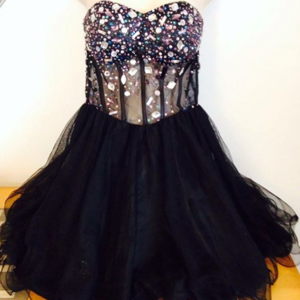 Small black corset like dress with embellishments